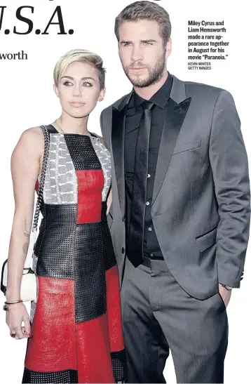  ?? KEVIN WINTER GETTY IMAGES ?? Miley Cyrus and Liam Hemsworth made a rare appearance together in August for his movie “Paranoia.”