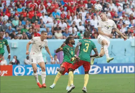  ?? (AFP) ?? Serbia’s defender Strahinja Pavlovic (right) heads the ball and scores his team’s first goal during the Qatar 2022 World Cup Group G football match against Cameroon at the Al Janoub Stadium on Monday.