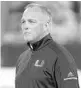  ?? BOB LEVERONE/AP ?? Miami coach Mark Richt watches his team warm up before the ACC title game.