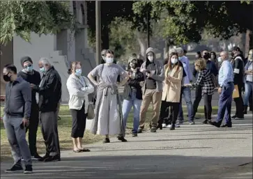  ?? Luis Sinco Los Angeles Times ?? A LINE for healthcare workers to get the COVID- 19 vaccine Tuesday in Lincoln Park. “I couldn’t not take the opportunit­y to protect myself,” said a woman who was vaccinated despite not working in healthcare.