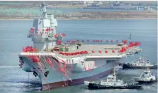  ??  ?? China's first domestical­ly built aircraft carrier is seen during its launching ceremony in Dalian, Liaoning province, China, April 26, 2017. Reuters