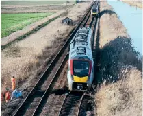  ?? AL PULFORD ?? Right: No. 755331 balanced precarious­ly on the washed out track alongside the New Cut at Haddiscoe on January 30. Thankfully the driver stopped in time and no one was injured. No. 755405 in the background had been sent to help with the rescue.