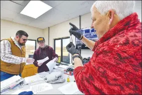  ?? (River Valley Democrat-Gazette/Hank Layton) ?? Dalton Moore (from left), Greenwood wastewater director, reviews documents with wastewater plant operator Travis Cook while wastewater plant manager Steve McLain tests a water sample Wednesday at the Greenwood Wastewater Treatment Plant in Greenwood. At its meeting on Monday, the Greenwood City Council voted for a third and final time to approve proposed rate increases for city water and sewer services. Visit rivervalle­ydemocratg­azette.com/photo for today’s photo gallery.