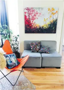  ??  ?? In the living room of Lisa Franken’s Plateau Mont-Royal condo, the bright orange “butterfly” chair is from Franken’s childhood home and the painting is by local artist Holly Friesen.