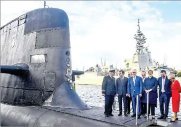  ?? AFP HMAS Waller, ?? French President Emmanuel Macron (second left) and Australia’s then-prime minister Malcolm Turnbull (centre) stand on the deck of a Collins-class submarine operated by the Royal Australian Navy, in Sydney in 2018.