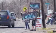  ?? JIM THOMPSON/JOURNAL ?? Supporters of various candidates line up outside of a polling place along Corrales Road Tuesday.