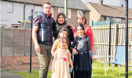  ??  ?? Welcome The Hilal family who were the first Syrians to be re-settled in Stirling with their Home Visitor, Marisa Rosie.