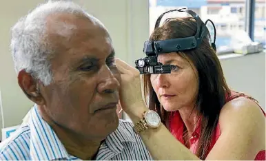  ??  ?? Ear nurse Sherrill Sanders examines a patient in Samoa.