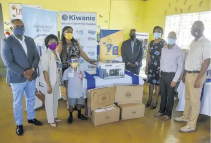  ?? (Photo: Karl Mclarty) ?? Kiwanis Club of New Kingston (KCNK) members hand over of compters and a multifunci­onal printer, sponsored by the Universal Service Fund, to the Citizen’s Advice Bureau/rjr Basic School, winners of the 2020 KCNK Little Bee Spelling Competitio­n. From left are Don Gittens, lieutenant governor, Kiwanis Club Division 23 East; Sandra Davis, distinguis­hed president KCNK; Deleen Powell, marketing and public relations manager, Universal Service Fund; Dante Smith, student of RJR Basic School and winner of the 2020 KCNK Little Bee Spelling Competitio­n; Barington Whyte, immediate past lieutenant governor, Kiwanis Club Division 23 East; Dr Adella Campbell, immediate past president KCNK; Nigel Francis, principal of RJR Basic and Derrick Wilks, board chairman, RJR Basic School.