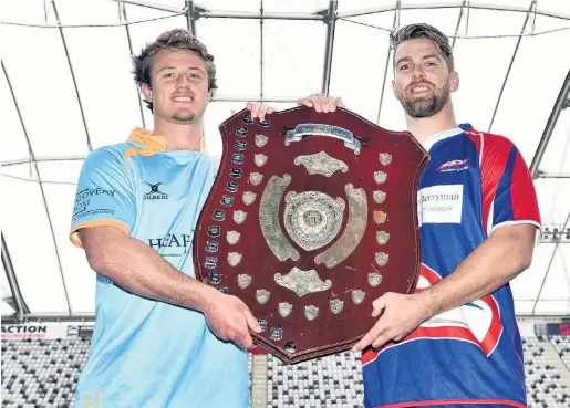  ?? PHOTO: PETER MCINTOSH ?? Tug of war . . . University captain Jack McHugh (left) and Harbour skipper Charles Elton get to touch the prize at stake in today’s Dunedin premier final.