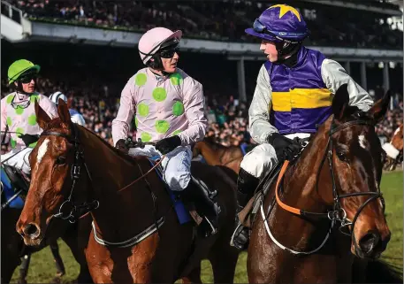 ??  ?? Latest Exhibition, with Bryan Cooper up, right, and Monkfish, with Paul Townend up, in conversati­on after finishing the Albert Bartlett Novices’ Hurdle on Day Four of the Cheltenham Racing Festival at Prestbury Park in Cheltenham. Photo Sportsfile