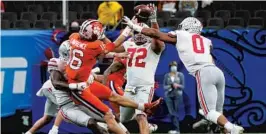  ?? GERALD HERBERT/AP ?? Clemson’s Trevor Lawrence tries to pass during the second half against Ohio State in the Sugar Bowl on Friday at Mercedes-Benz Superdome in New Orleans.