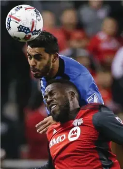  ?? RICK MADONIK/TORONTO STAR ?? Impact defender Victor Cabrera heads the ball away from TFC’s Jozy Altidore, who scored the lone goal in Sunday’s encounter in the 16th minute.