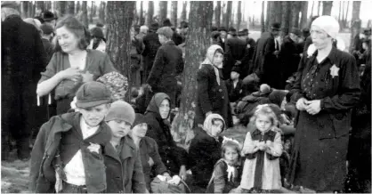 ??  ?? LEFT: Birkenau, Poland, May 1944. Jewish prisoners wait near gas chamber number 4, before being sent to their deaths