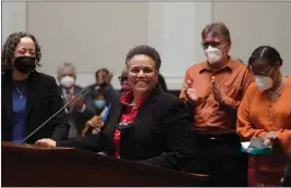  ?? JEFF CHIU — THE ASSOCIATED PRESS ?? Judge Kelli Evans, middle, smiles after speaking during a public hearing in San Francisco on Thursday held by the Commission on Judicial Appointmen­ts to consider her selection to the California Supreme Court.