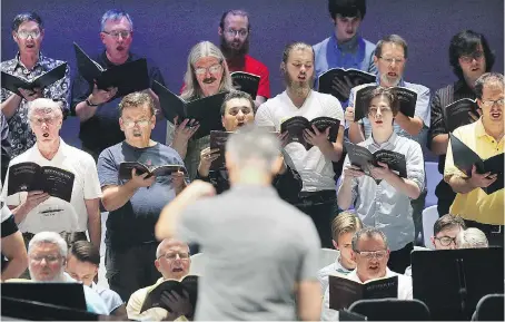  ?? DAN JANISSE ?? Windsor Symphony Orchestra maestro Robert Franz, foreground, leads a rehearsal with the group’s chorus at the Capitol Theatre Wednesday. The WSO will perform a triple celebratio­n themed concert on Saturday for Canada’s 150th, Windsor 125th, and the...