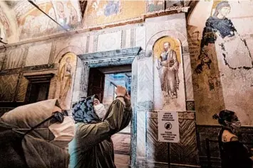  ?? BURAK KARA/GETTY ?? Church converted: Tourists on Friday visit Istanbul’s Church of St. Saviour in Chora. On the same day, the Turkish government formally converted the church, which dates to the 4th century, into a mosque. The move came about a month after Turkish President Recep Tayyip Erdogan turned the landmark Hagia Sophia museum into a Muslim house of prayer.