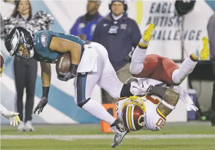  ?? PHOTOS BY MICHAEL PEREZ/ASSOCIATED PRESS ?? The Eagles’ Golden Tate, left, is tackled by the Redskins’ Ha Ha Clinton-Dix on Monday in Philadelph­ia. Tate finished with 85 yards and a touchdown in the Eagles’ 28-13 win.