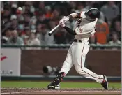  ?? JEFF CHIU — THE ASSOCIATED PRESS ?? The Giants’ Mike Yastrzemsk­i hits a home run against the Padres during the fourth inning Monday in San Francisco.