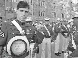  ??  ?? Spenser Rapone displays a sign inside his hat touting communism after graduating in 2016 from the United States Military Academy at West Point, N.Y. After Rapone, who was a combat veteran who served in Afghanista­n, posted the photo on Facebook, the...