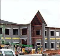  ?? / John Popham ?? Red brick is being laid on the new Main Elementary School building on Martin Luther King Jr. Boulevard. The school is scheduled to be completed by August according to city school Superinten­dent Lou Byars.