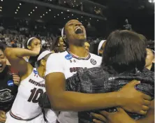  ?? Rich Pedroncell­i / Associated Press ?? South Carolina guard Kaela Davis and teammates celebrate in Stockton after defeating Florida State to reach the Final Four.