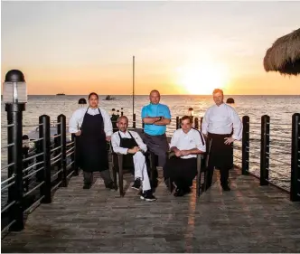  ??  ?? Clockwise from above: Marseille-based Michel Portos (seated to the left) with Shangri-La chefs Gilles Galli, Joris Rucken, Alain Rion, and Anna Atilon; scallop carpaccio with squidink tuile, created by Galli as a starter for dinner on the second night of Reservatio­ns in Paradise; day two’s lunch on the lawn of the resort’s Alon Garden.