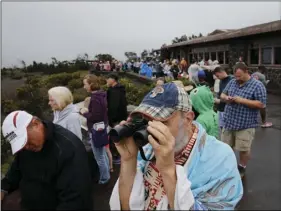  ??  ?? Visitors view Kilauea’s summit crater outside the Jaggar Museum in Volcanoes National Park, Hawaii, Thursday. AP PHOTO/JAE C. HONG