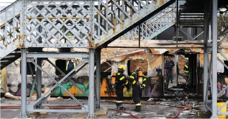  ?? Picture: Tracey Adams/African News Agency (ANA) ?? GUTTED: Yesterday morning a train pulled into Retreat station billowing smoke and flames from two carriages. The flames were quickly extinguish­ed and the train remained parked at Retreat station.