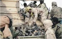  ??  JEROME DELAY/THE ASSOCIATED PRESS FILES ?? Chadian soldiers collect weapons seized from Boko Haram fighters in Damasak, this month.