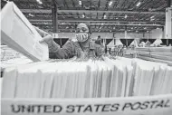  ?? Associated Press file photo ?? A Harris County election worker prepares mail-in ballots in 2020. Today, an unpreceden­ted number of applicatio­ns for such ballots in Texas are being rejected.