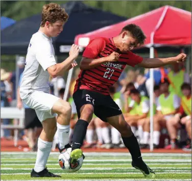  ?? (Arkansas Democrat-Gazette/Colin Murphey) ?? Henry Ross of Conway (left) battles for possession with Ceasr Olvera of Fort Smith Northside in the Class 6A boys soccer state championsh­ip game Saturday at Benton Athletic Complex in Benton. Conway defeated the Grizzlies 3-1 for their first state title since 2008.