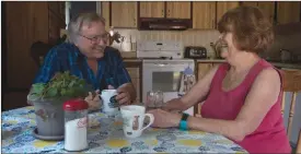  ?? The Canadian Press ?? Bonnie and Doug Main share a laugh at their kitchen table.