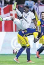  ??  ?? Alphonso Davies, 16, gets a rude introducti­on to the MLS during Champions League action against New York on March 2.