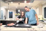  ?? RAY CHAVEZ — STAFF PHOTOGRAPH­ER ?? Sean Cook and daughter Emma, 10, prepare dinner. Cook and his wife paid $1.9 million for their San Jose house in 2012. It’s now listed at $2.9 million, down from $3 million.