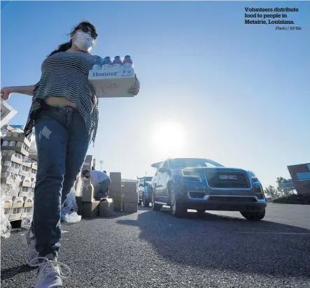  ?? Photo / AP file ?? Volunteers distribute food to people in Metairie, Louisiana.