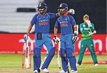  ?? AFP ?? India’s batsmen Virat Kohli (left) and Ajinkya Rahane celebrate the 100- run stand during the first ODI against South Africa at Kingsmead Cricket Ground on Thursday.