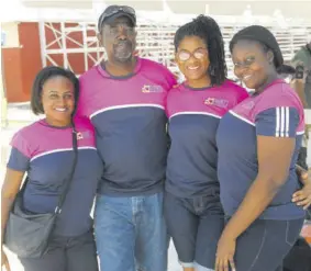  ?? (Photo: Paul Reid) ?? Wayne Long with members of his staff at Ondirun at the CCCJ Championsh­ips at G C Foster last year.