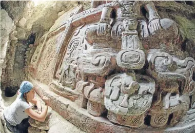  ?? Photo: REUTERS ?? ‘A great work of art’: Archaeolog­ist Anya Shetler works on part of the Mayan frieze found at the Holmul site in northern Guatemala. The detailed sculpture depicts deities and rulers above a 30-glyph inscriptio­n.