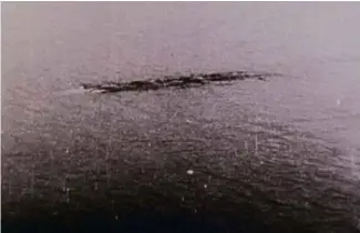  ??  ?? CENTRE: A ripple, a log or a giant eel? ABOVE: Ivor Newby, in pursuit of Nessie.