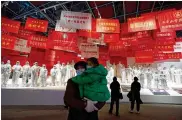  ?? NG HAN GUAN / ASSOCIATED PRESS ?? Residents attend an exhibition on the city’s fight against the coronaviru­s in Wuhan in central China on Saturday. Wuhan accounted for the bulk of China’s 4,635 deaths from COVID-19.