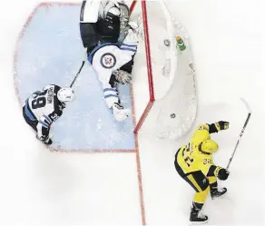  ?? MARK HUMPHREY/THE ASSOCIATED PRESS ?? Despite losing Game 2 on a goal by Nashville’s Kevin Fiala in double OT, the Winnipeg Jets are taking solace in the way they kept battling back Sunday just to force overtime.