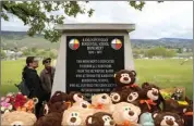  ?? MERT ALPER DERVIS / GETTY IMAGES ?? People view a monument on May 23 near the site of the former Kamloops Indian Residentia­l School in British Columbia, Canada. A ceremony was held that day marking the first anniversar­y of the discovery of the unmarked graves of 215 indigenous children. The school, which was opened in the late 19th century to assimilate indigenous kids, closed in the late 1970s.