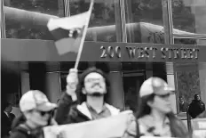  ?? Reuters photo ?? Protesters demonstrat­e outside of Goldman Sachs headquarte­rs after the company purchased Venezuelan bonds in New York, US.