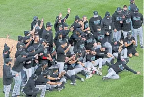  ?? Jonathan Daniel, Getty Images ?? The Marlins celebrate a win over the Chicago Cubs during Game 2 of the National League Wild Card Series at Wrigley Field on Friday.