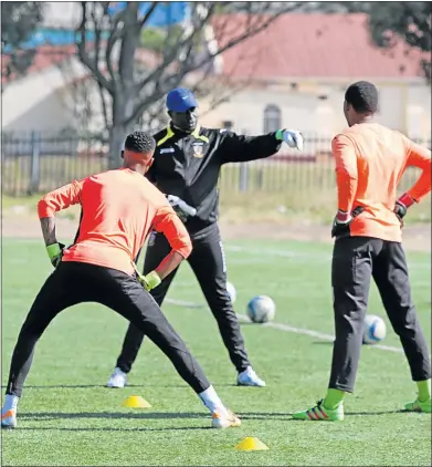  ?? Picture: ZINGISA MVUMVU ?? NO CRISIS: Mthatha Bucks goalkeeper coach Postnet Omony, centre, doing some drills with the club's goalkeeper­s during a training session. Omony believes there’s no need to press the panic button yet even though the side is failing to deliver the goods
