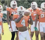  ?? ELLIS RUA/MIAMI HERALD ?? Wide receiver Jeff Thomas catches a ball during the team’s practice in Coral Gables on Tuesday.