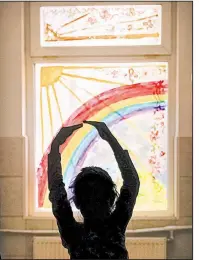  ?? AP/VADIM GHIRDA ?? Sara, a child living at the Robin Hood orphanage in Bucharest, Romania, tries a ballet move last month in a corridor at the facility.