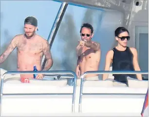  ??  ?? Sun-loving Becks and Marc Anthony with Posh in her high-necked black dress