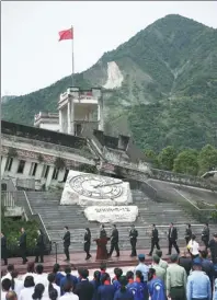  ?? ZOU HONG / CHINA DAILY ?? At the site of Xuankou Middle School, people gather on Saturday for a memorial service marking the 10th anniversar­y of the Wenchuan Earthquake in Sichuan province that killed nearly 70,000 people.